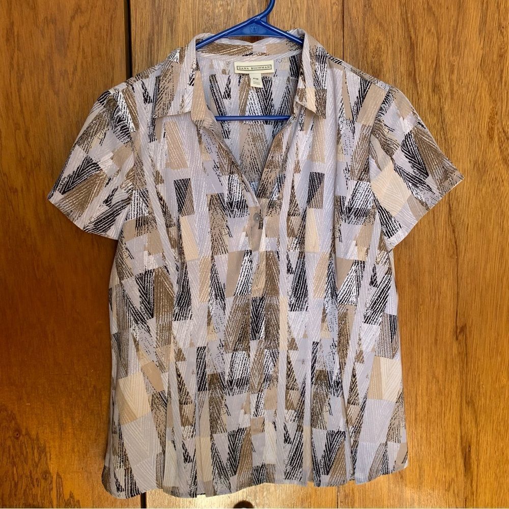Dana Buchman short sleeve button down blouse. Slight flare to hemline petite med